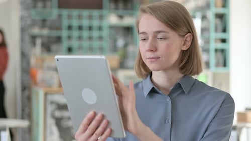 Woman Using Tablet Computer Indoors