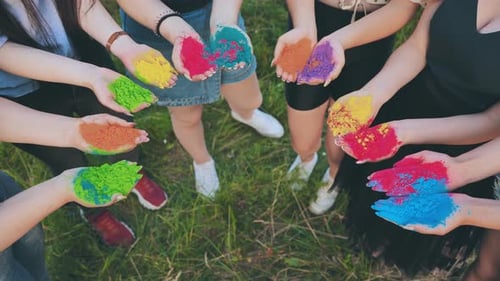 Friends Holding Colorful Powder for Holi Celebration