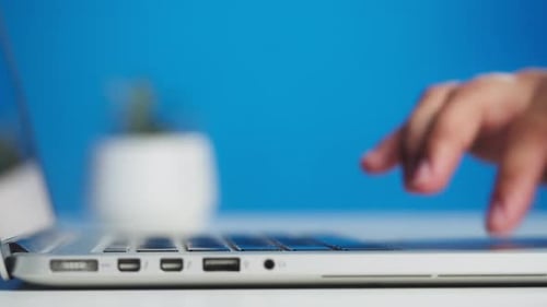 Hands Typing on Laptop Keyboard Close Up