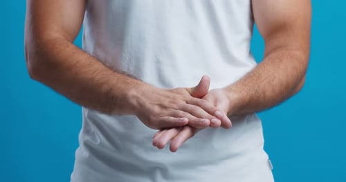 Man Applying Moisturizer Cream to Hands