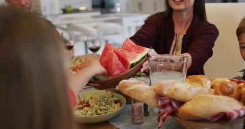 Family Enjoys Meal Together at Home Dining Table