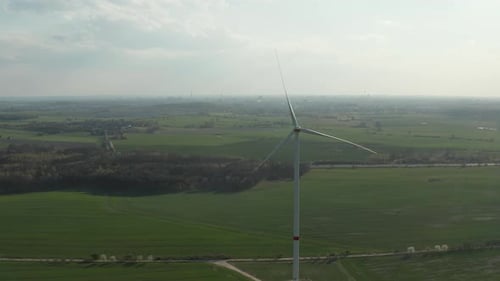 AERIAL: Close Up Shot of Wind Mill Rotating By the Force of the Wind and Generating Renewable Energy
