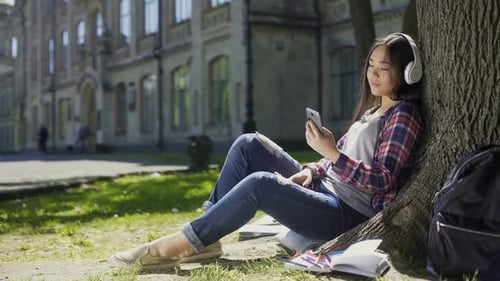 Relaxing Student Listening to Music on Campus