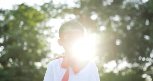 Hero boy in red laugh at garden