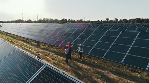Top View of Specialists Walking Across a Solar Power Plant