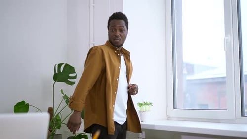 Man Works on Laptop at Home Office