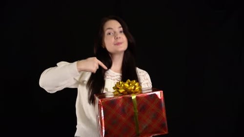 Woman Presents Wrapped Birthday Gift with Gold Bow