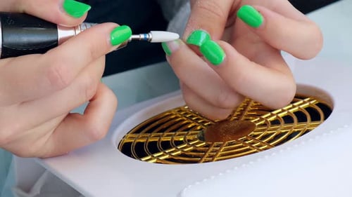 Woman Filing Her Nails With an Electric File