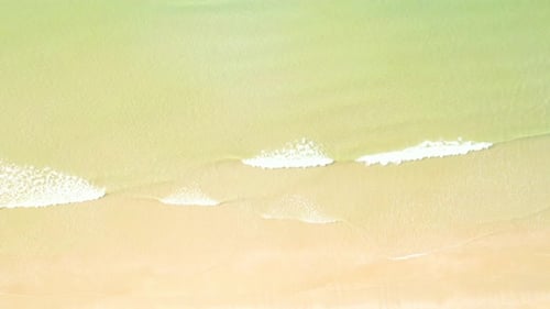4K Aerial view top view of drone, sea waves and beautiful sand beach.