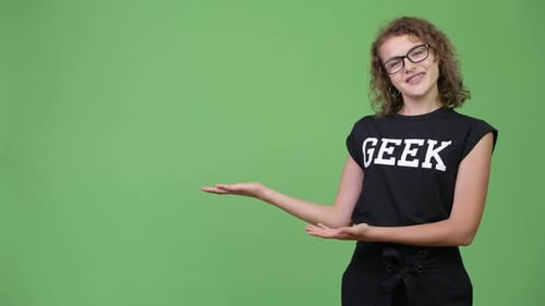 Young Woman Presenting to the Side on Green Screen
