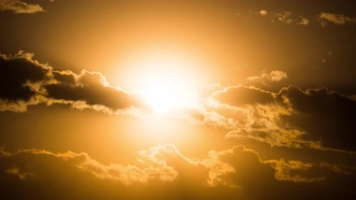 Golden Sun Shining Through Moving Clouds Time Lapse