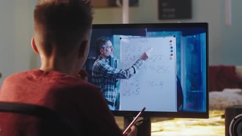 Boy Learning Math Remotely with Tutor on Computer