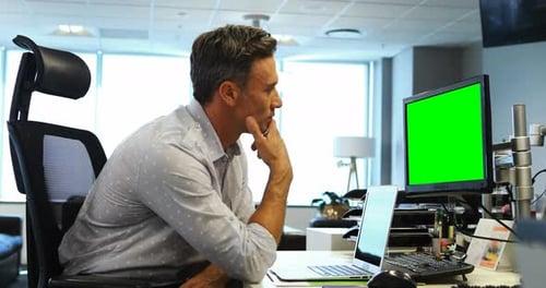 Man Working At Desk On Laptop