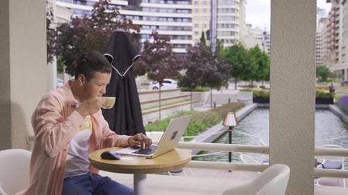 Young businessman rejoicing in cafe.