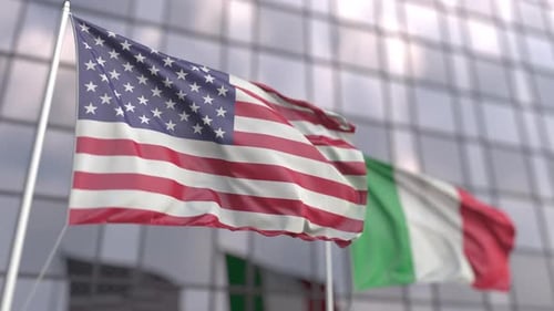 Waving Flags of the United States and Italy in Front of a Skyscraper