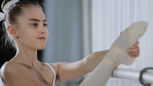 Girl Stretching at Ballet Barre