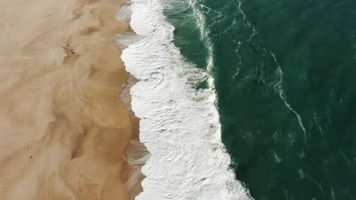 Aerial Top View of Ocean Blue Waves Break on a Beach
