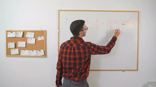 Teacher Writing Math Equations on Whiteboard