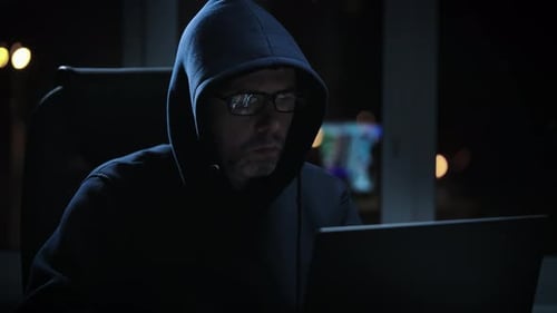 Hacker in a Dark Room Writes Malicious Code