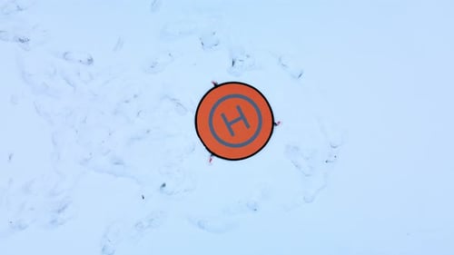 Drone Parking Apron Pad. Lies in the snow.