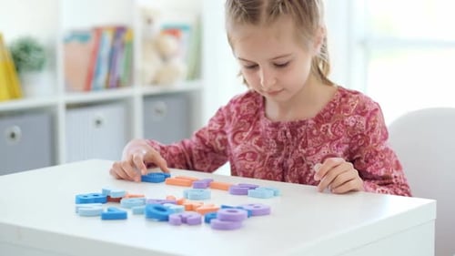 Child Learning Math with Colorful Foam Numbers