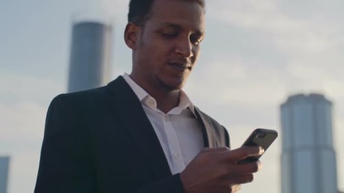 Man Using Phone in City Downtown