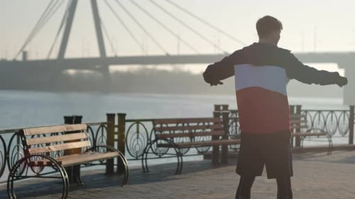 Young Man Is Warming Up and Starts To Run