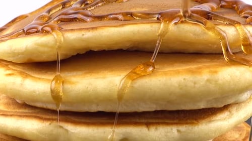 Golden Syrup Poured on a Stack of Pancakes