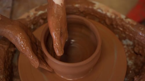 Hands Shaping Clay Bowl on Pottery Wheel