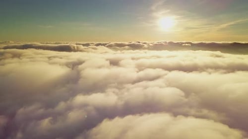 Aerial View of Fluffy Clouds at Sunrise