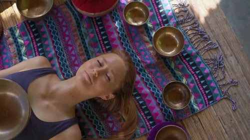 Woman Relaxing with Sound Therapy Bowls