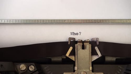 Typing word Who ? on retro typewriter. Close up.