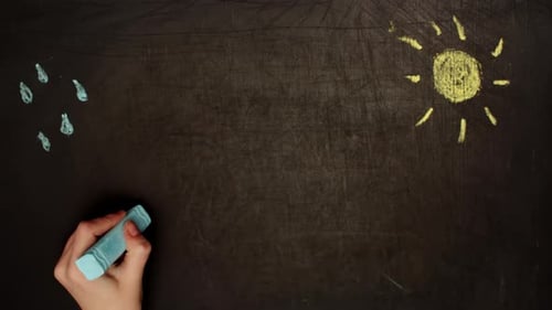 Rainbow Chalk Drawing on Blackboard with Sun and Rain