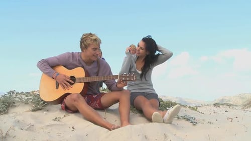 Friends Enjoying Beach, Guitar, and Refreshments