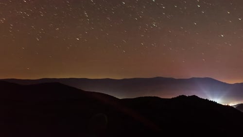 Star Trails Over Rolling Mountain at Night