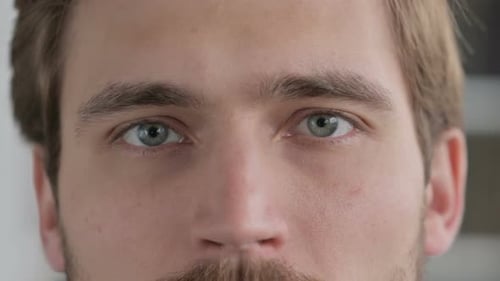 Close Up of Blinking Eyes of Man Looking at the Camera
