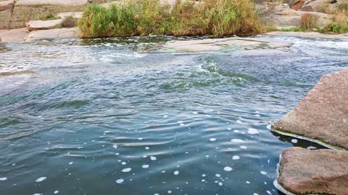 A Small Shining Stream Flows Among Smooth Wet and Dark Stones
