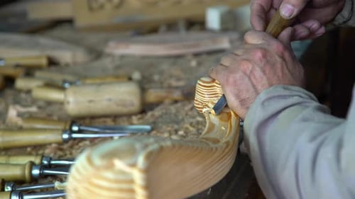 Artisan Carving Intricate Wood Design in Workshop