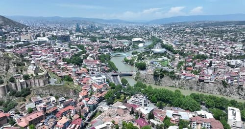 Aerial view of Tbilisi city central park and Bridge of Peace. Beautiful cityscape of old Tbilisi at
