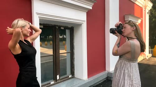 Blonde Woman Poses For Photographer Outside Building