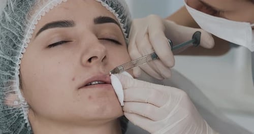Young Adult Woman Receives Lip Filler Procedure