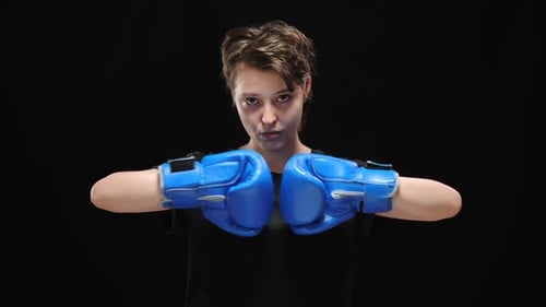 Person Wearing Boxing Gloves Stares Intently