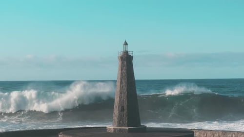 Slow Motion Strong Waves Crash Against a Lonely Lighthouse in the Open Ocean