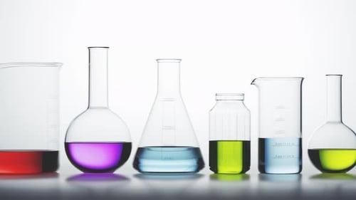 Clean Panning Shot of Laboratory Glassware with Colorful Liquids