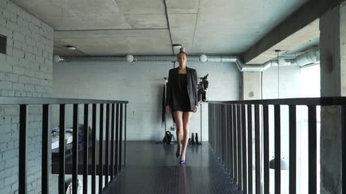 Blonde Woman Walking Fashionably in Loft