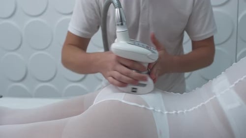 Woman Receiving Therapeutic Massage in White Body Suit