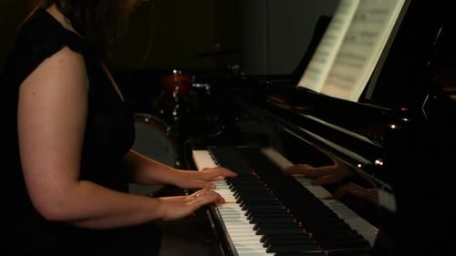 Woman Playing Piano in a Music Studio
