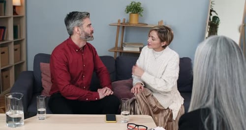 Crop View of Married Emotional Couple Discussing Family Problems While Sitting at Female