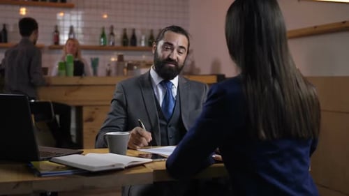 Man and Woman Shaking Hands After Meeting