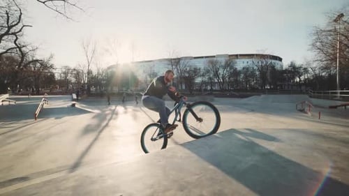 MTB Bicycle Rider Does Various Tricks While Riding in Skatepark